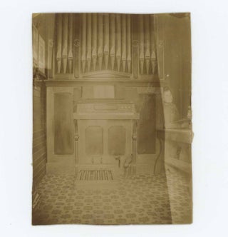 Item #29848 [Photograph of a Woman With a Ghostly Demeanor Seated by a Pipe Organ]. Photographer...